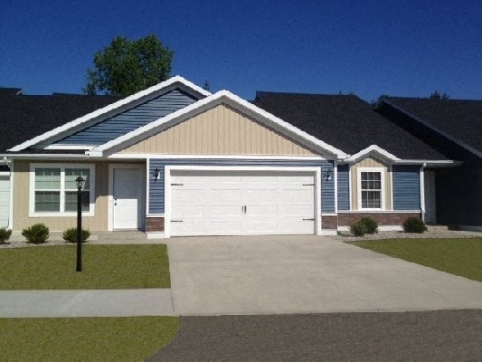 a blue house with a white garage door