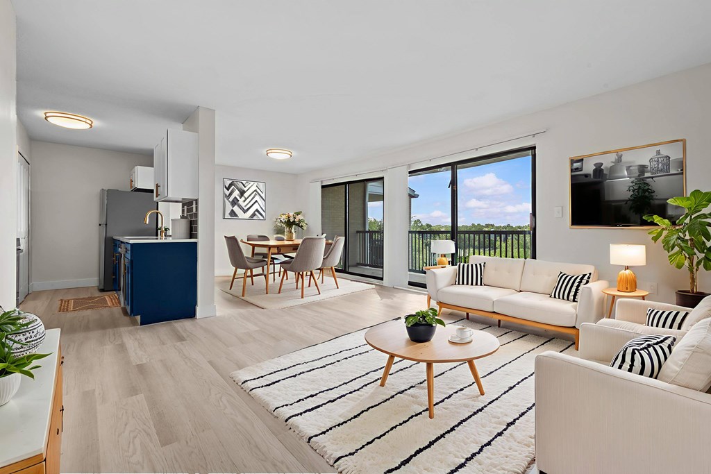 A modern living room with a blue kitchen island and a white sofa.
