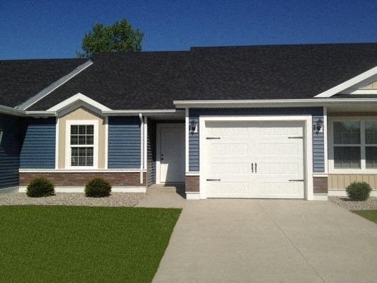 a home with a white garage door in front of it