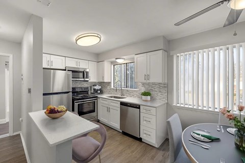A modern kitchen with a dining table and chairs.