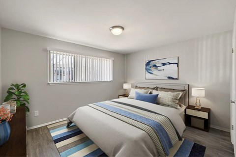 A bedroom with a large bed and a painting on the wall.