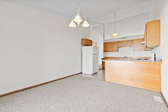 a kitchen with a white refrigerator and a wooden cabinet
