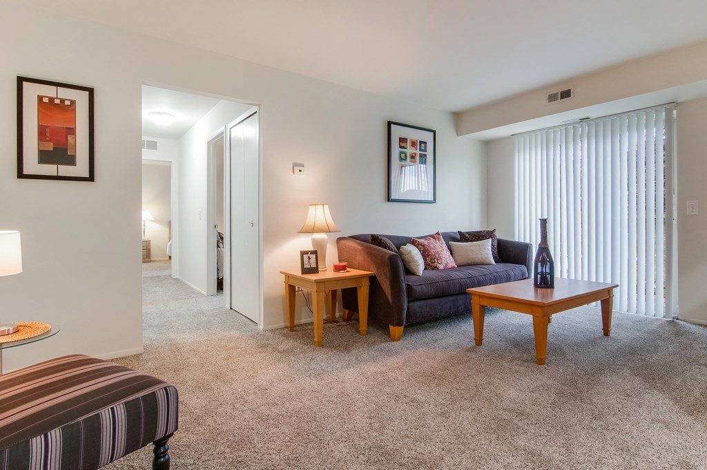 a living room with a couch and two tables
