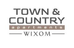 the logo of the town  country apartments at night at Town & Country Apartments - Wixom, MI, Michigan