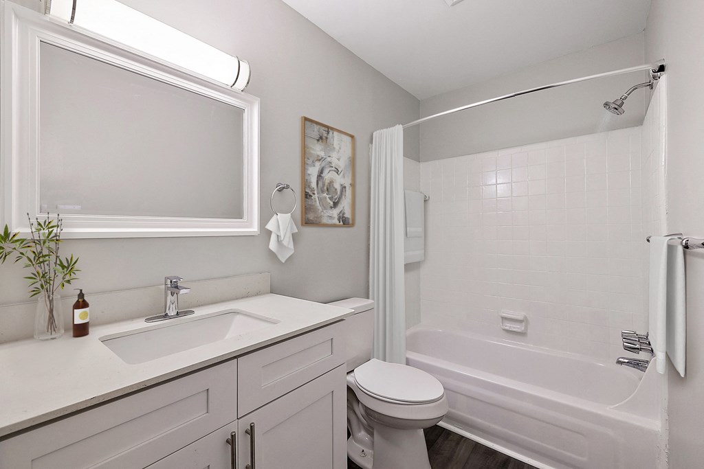 a white bathroom with a sink toilet and tub