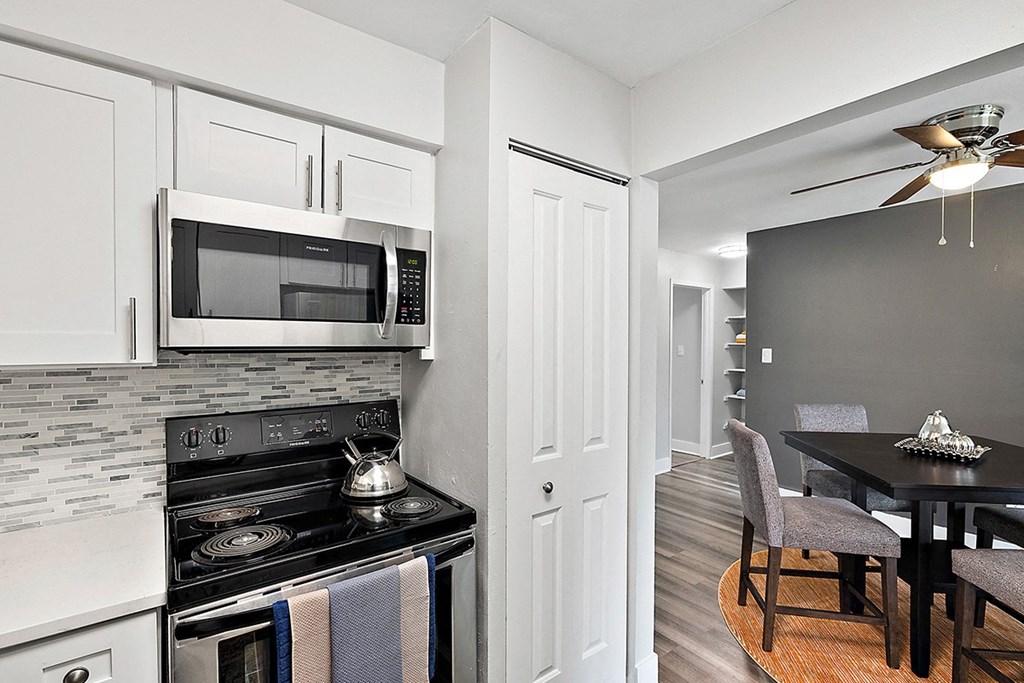 a kitchen with a stove and a microwave