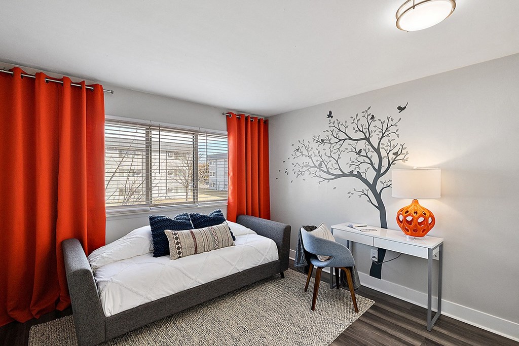 a bedroom with a bed and a desk