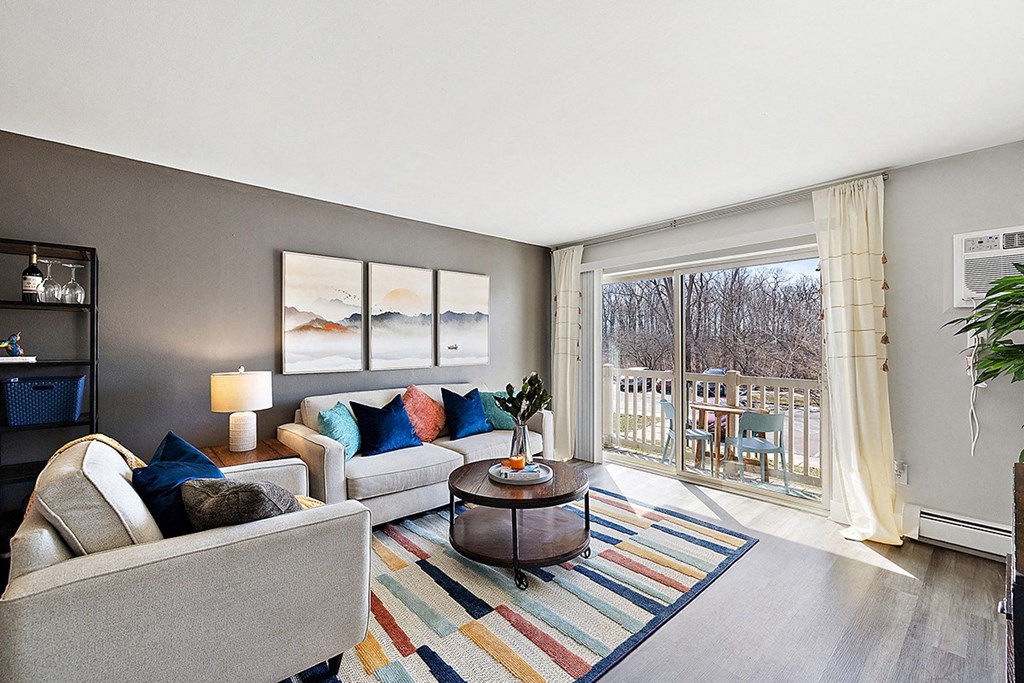 a living room with a sliding glass door to a balcony