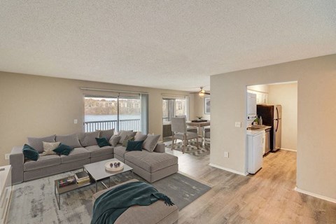 A living room with a grey couch and a coffee table.
