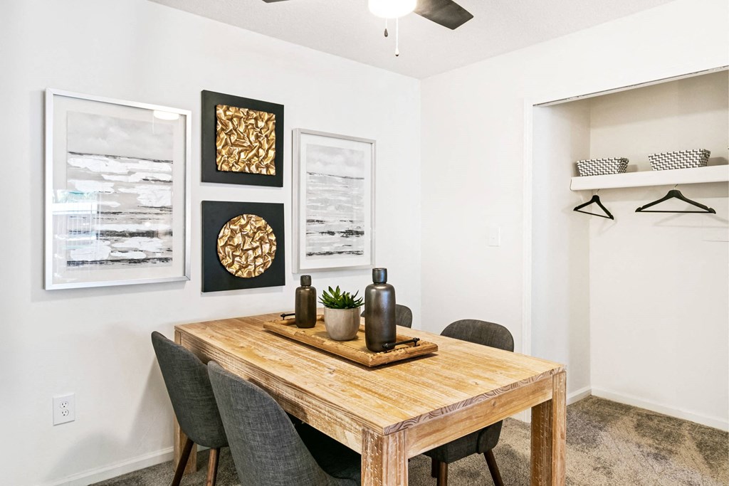 A dining room with a wooden table and chairs at The Waverly on the Lake - Belleville, MI Apartment , Michigan
