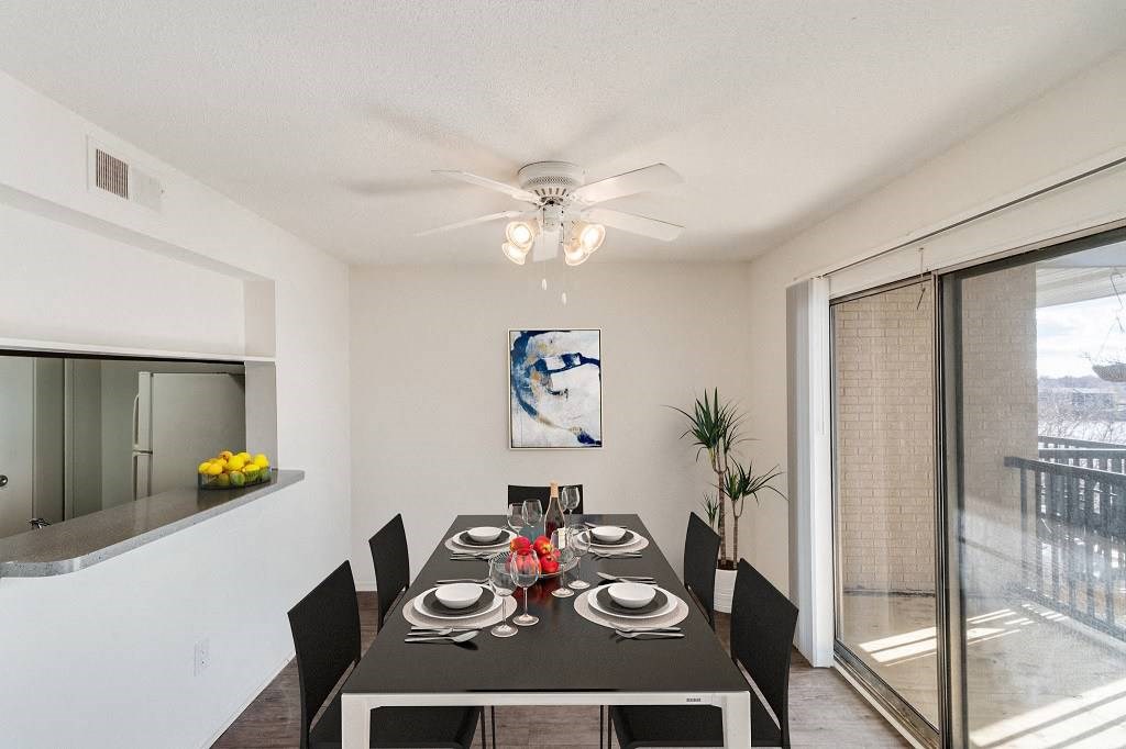 A dining room with a table set for six people. A dining room with a table set for six people at The Waverly on the Lake - Belleville, MI Apartment , Belleville, 95050