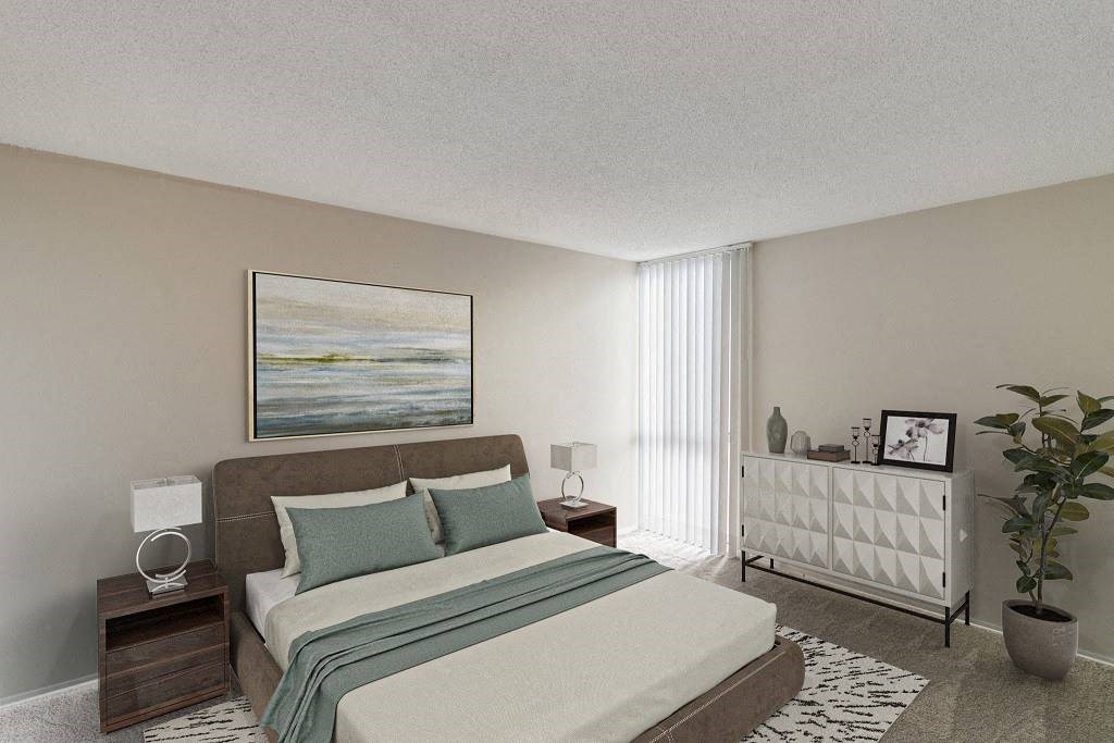 A bedroom with a large bed and a painting on the wall at The Waverly on the Lake - Belleville, MI Apartment , Belleville, Michigan