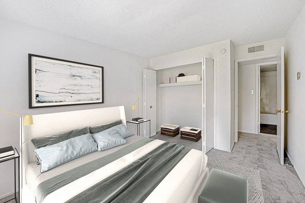 A bedroom with a bed, nightstands, and a painting on the wall at The Waverly on the Lake - Belleville, MI Apartment, Belleville, MI, 95050