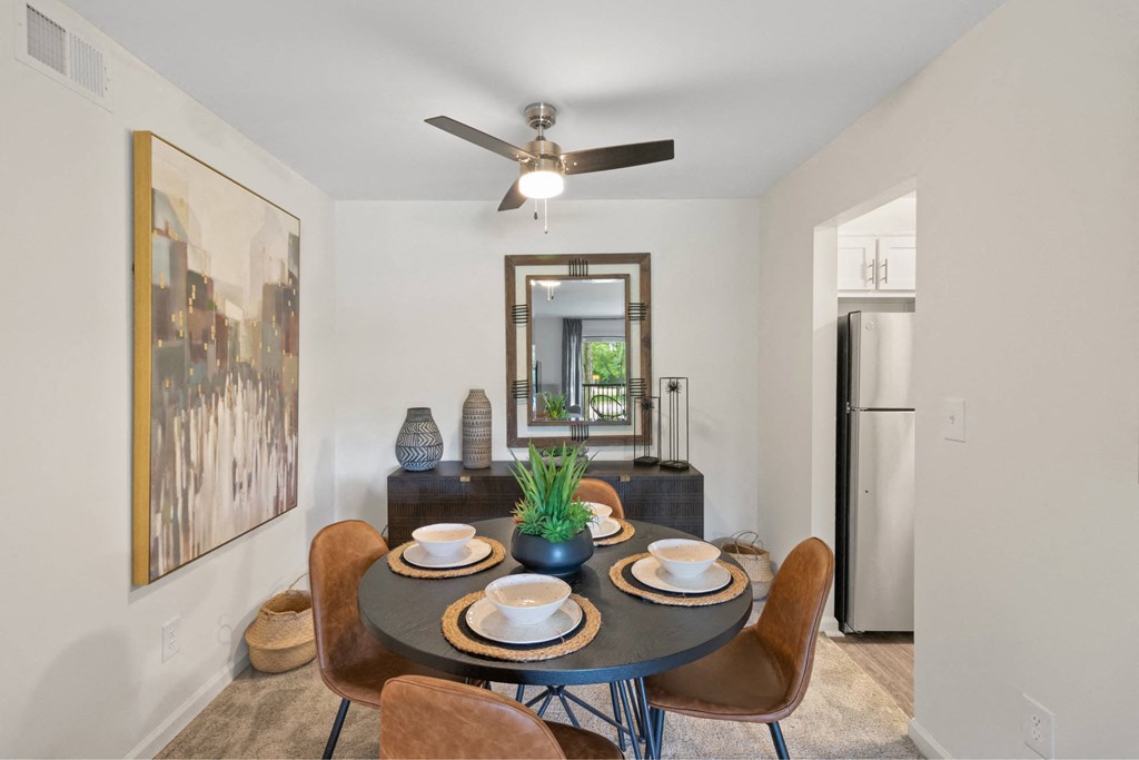 A dining room with a round table set for two at The Waverly on the Lake - Belleville, MI Apartment, Belleville, MI, 95050