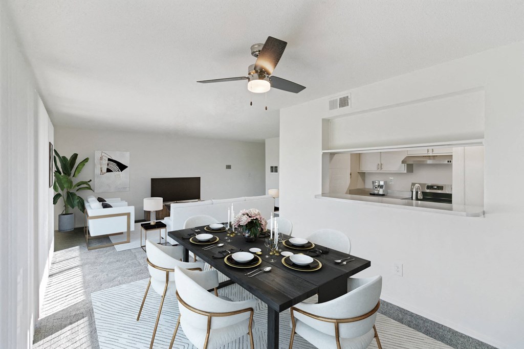 A modern dining room with a black table set for two at The Waverly on the Lake - Belleville, MI Apartment , Belleville, Michigan