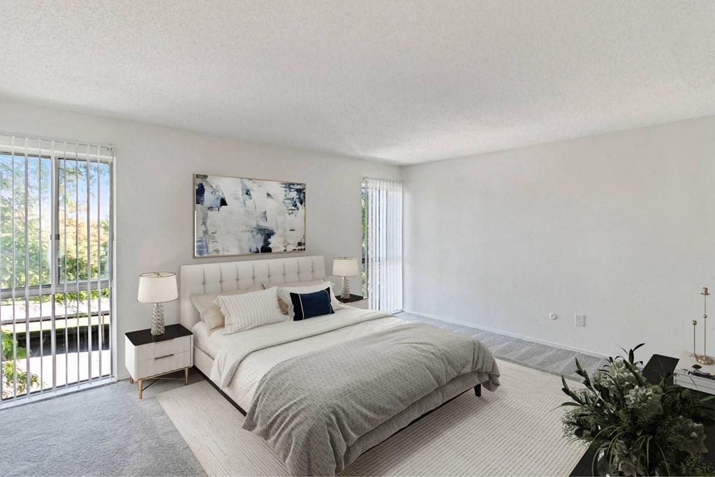 A bedroom with a large bed and a painting on the wall at The Waverly on the Lake - Belleville, MI Apartment , Belleville, 95050