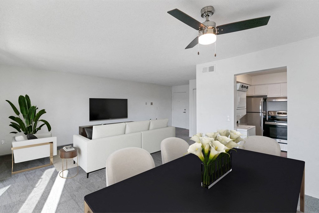 A black table with a vase of white flowers on it at The Waverly on the Lake - Belleville, MI Apartment , Belleville, Michigan