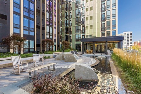 A modern building with a water feature in front.