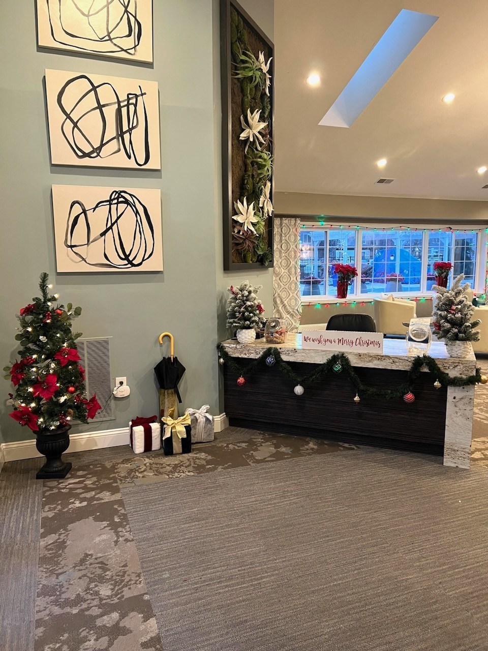 a christmas tree and presents in the lobby of a church