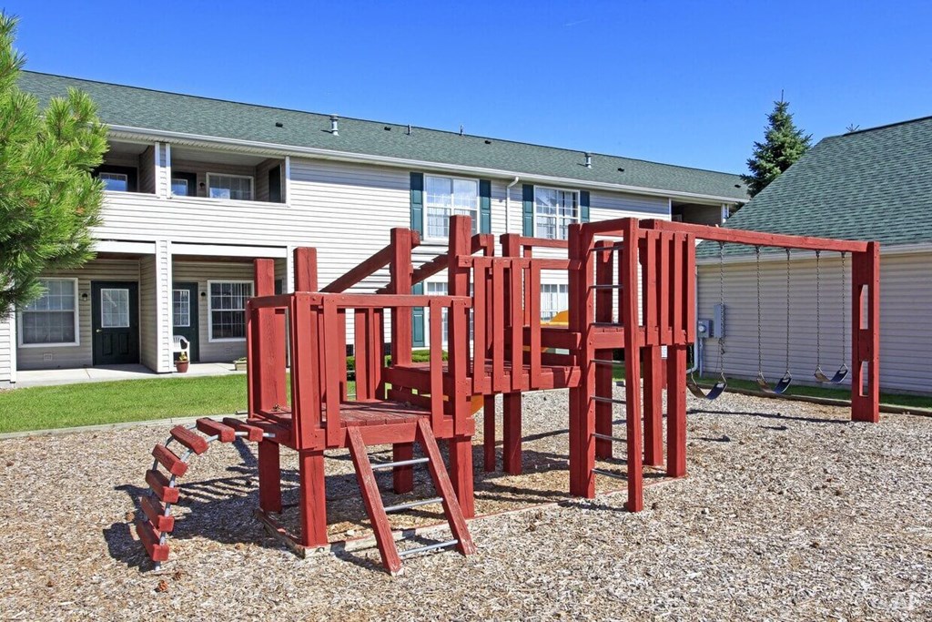 a picture of a play structure in front of a building