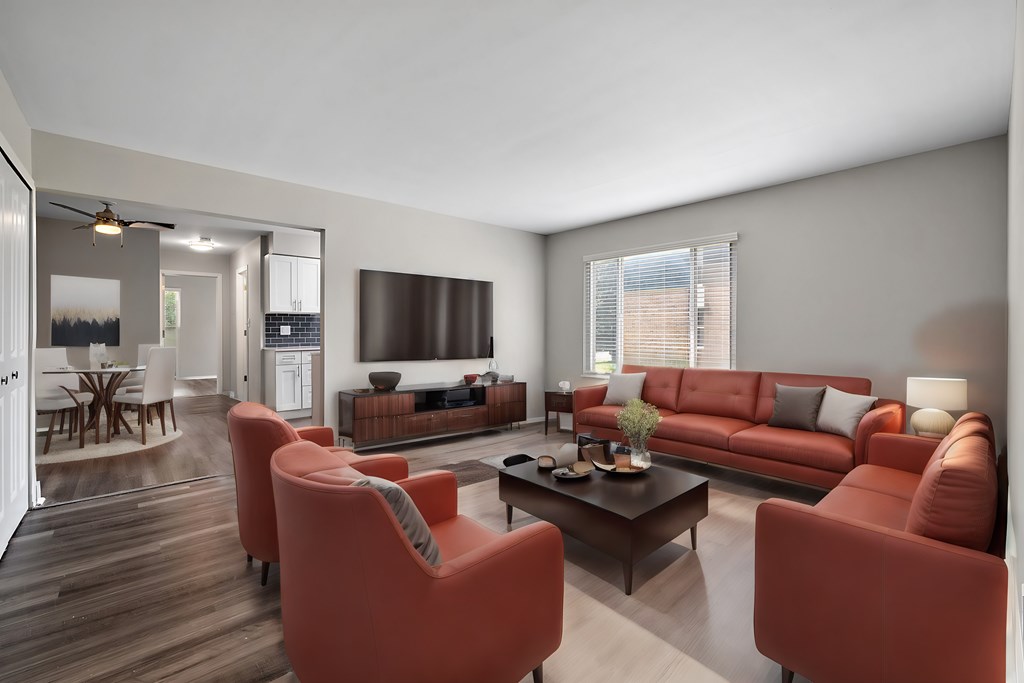 A living room with a red couch and a television.