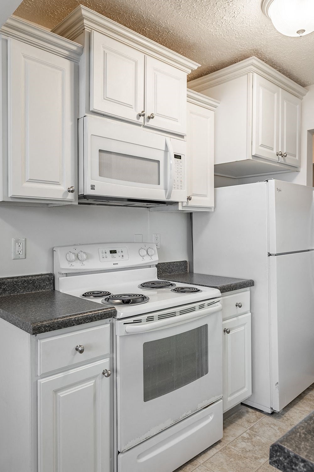 a kitchen with white appliances and white cabinets