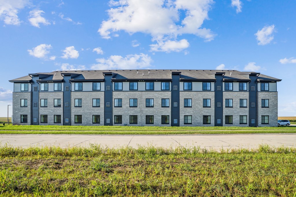 A large building with a flat roof and multiple windows.