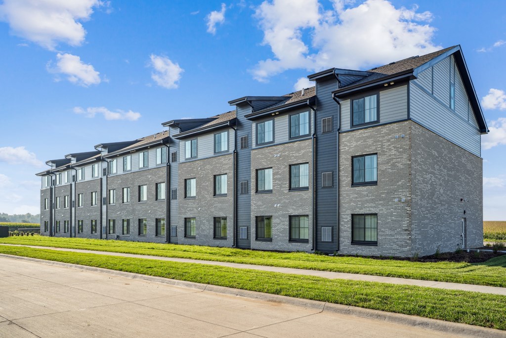 A large grey building with a lot of windows and doors.