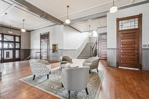 A living room with a grey sofa and a wooden door.