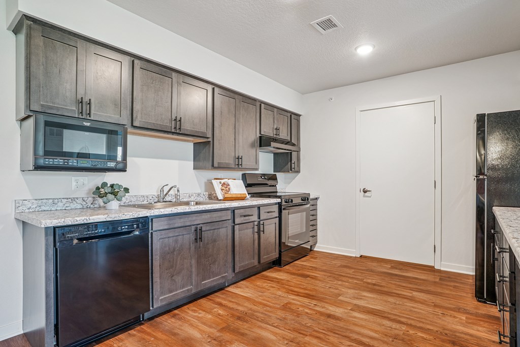 A kitchen with wooden cabinets and a white countertop.