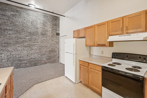 A kitchen with a white refrigerator and a white stove top oven.