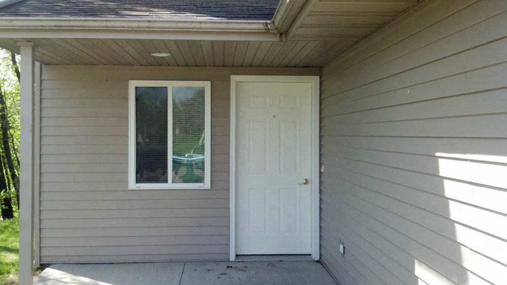 A small house with a white door and window.