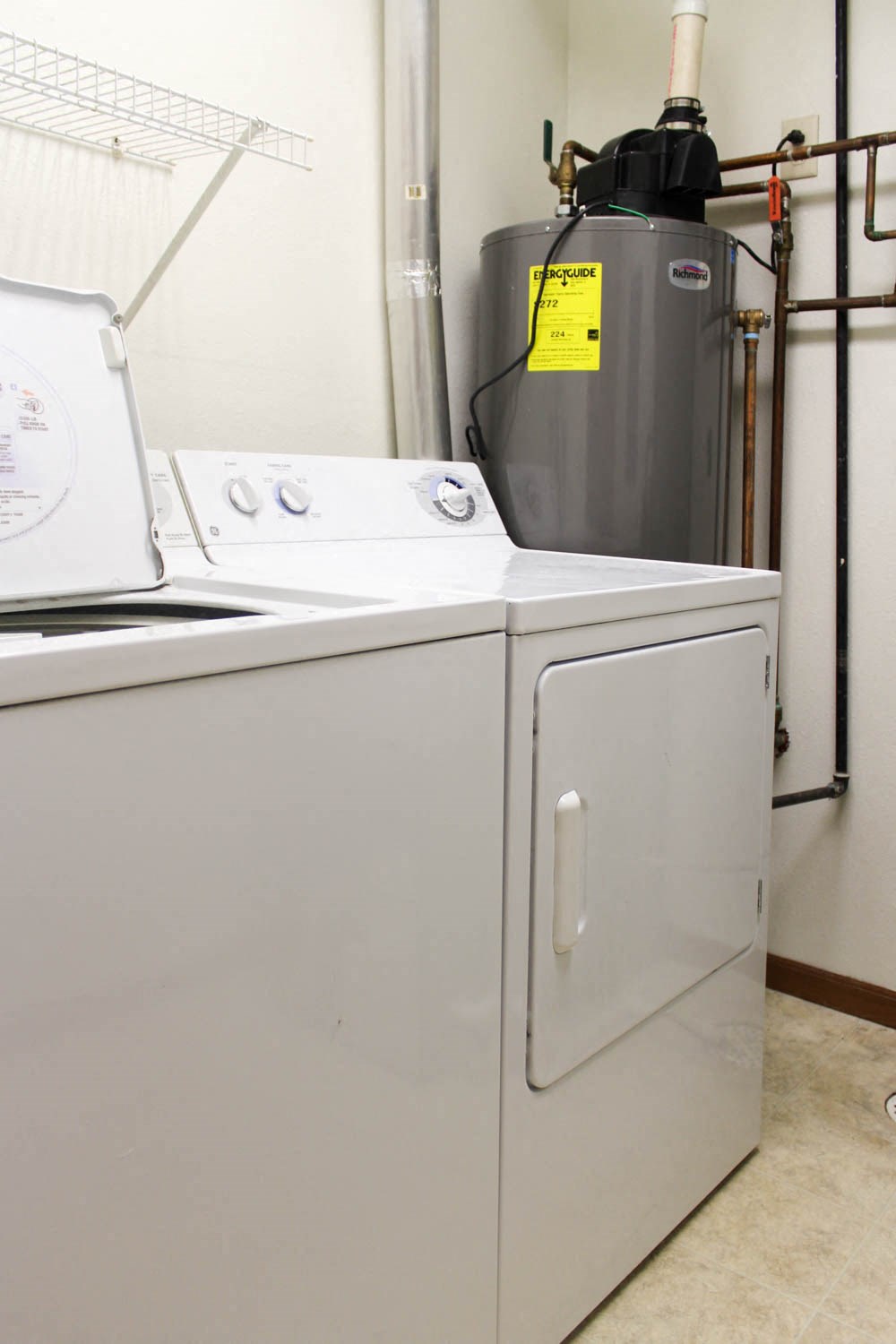 A washing machine and dryer in a small room.