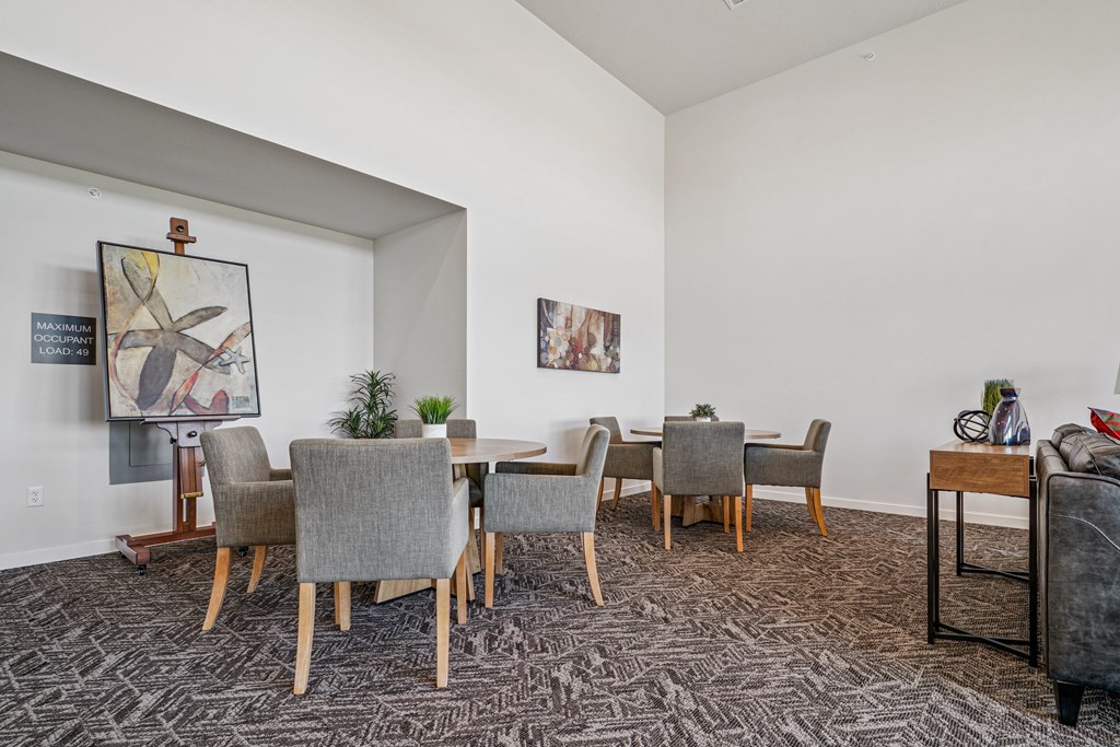 A dining room with a table and chairs.