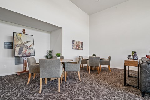 A dining room with a table and chairs.