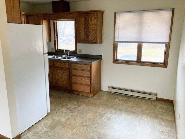 a small kitchen with a sink and a refrigerator