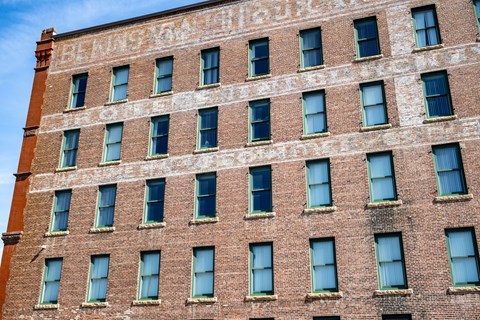 A brick building with the words "Bank of the West" written on it.
