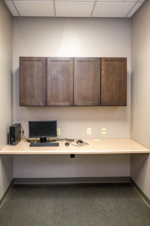 A workspace with a computer, keyboard, mouse, and headphones on a desk.