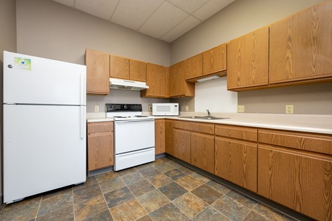 A kitchen with wooden cabinets and a white refrigerator.
