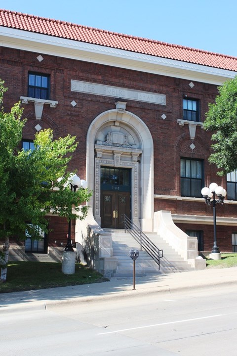 A red brick building with a large arched entrance.