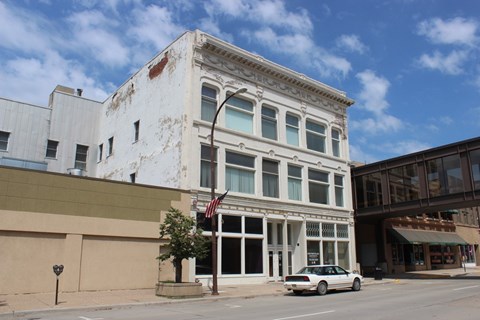 A white building with a flag on it.