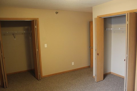 A room with a closet and a door.