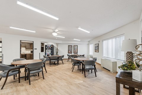 A dining room with a table and chairs.