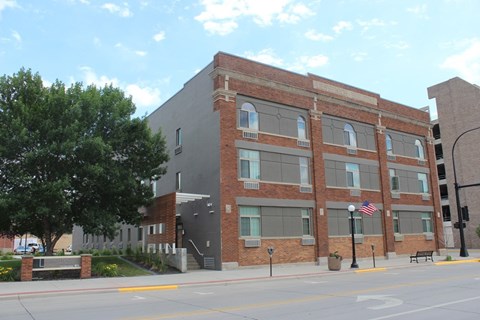 A brick building with a flag on the front.