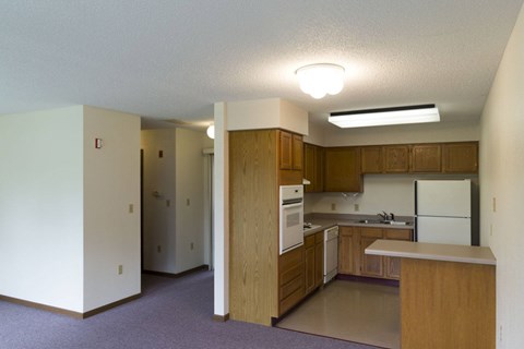 A kitchen with wooden cabinets and a white refrigerator.