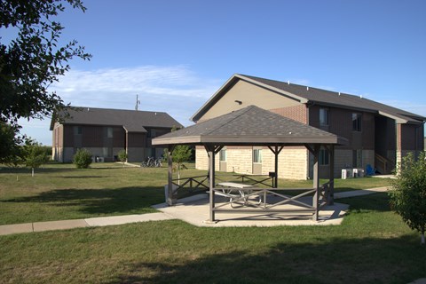 A large building with a covered patio in front.