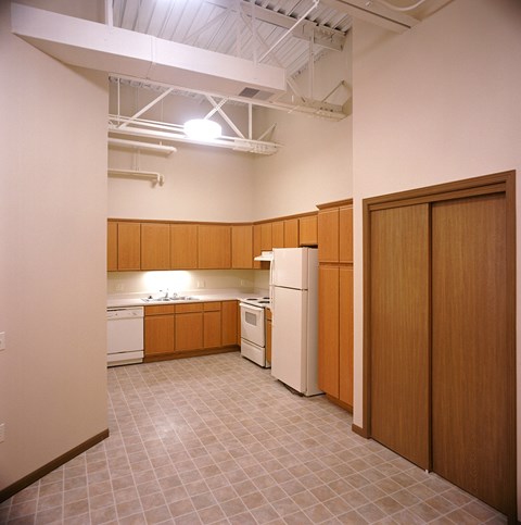 A kitchen with wooden cabinets and white appliances.
