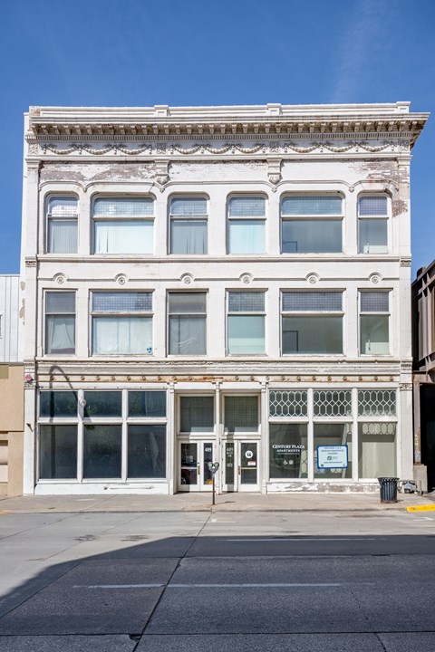 A white building with a blue sign on the front.