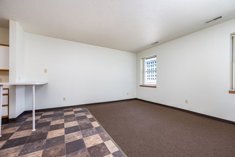 A room with a checkered floor and a window.