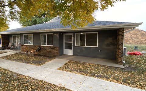 A house with a grey roof and a grey garage door.